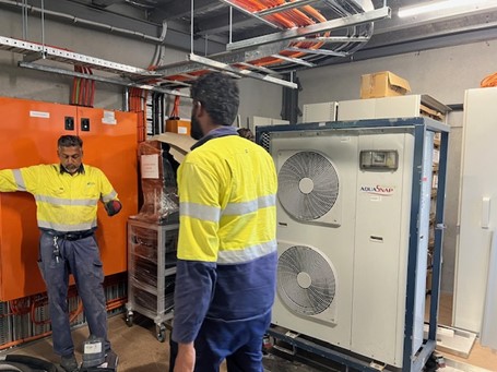 Technicians installing temporary chiller hire system for a medical manufacturing facility.