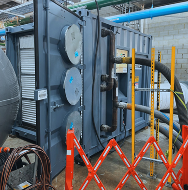 Temporary air handling unit installed inside a plant room during a pool redevelopment project in Perth, showing ducts and pipework connected to the industrial AHU.